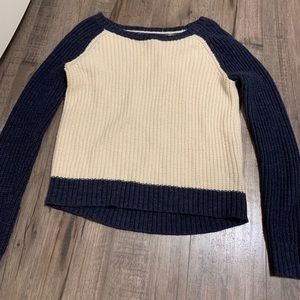 creme sweater with navy sleeves